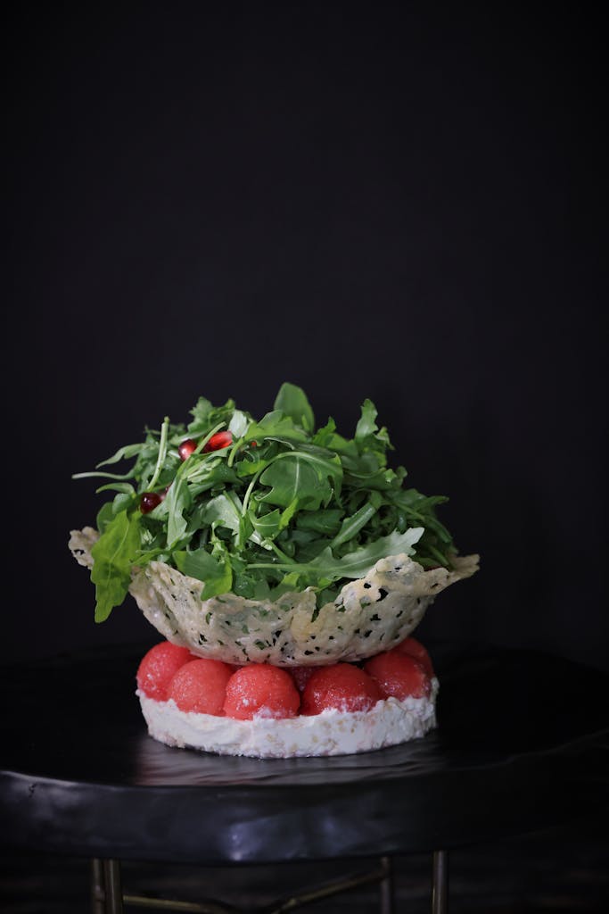 A gourmet salad with arugula and cherry tomatoes, nestled in a cheese basket.
